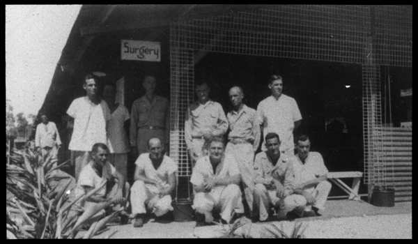Group of men outside of the Surgery building at U.S. Army, 27th General Hospital site.